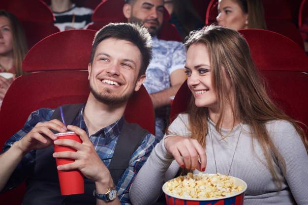 happy-cute-couple-eating-popcorn-and-laughing-at-funny-comedy-in-cinema-theater-attractive-girl-and-handsome-having-romantic-date-and-enjoying-interesting-movie-concept-of-entertainment_7502-5439.jpg